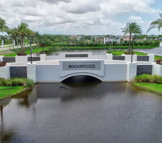 image of entrance to Boca Bridges community - a bridge with the community sign on it